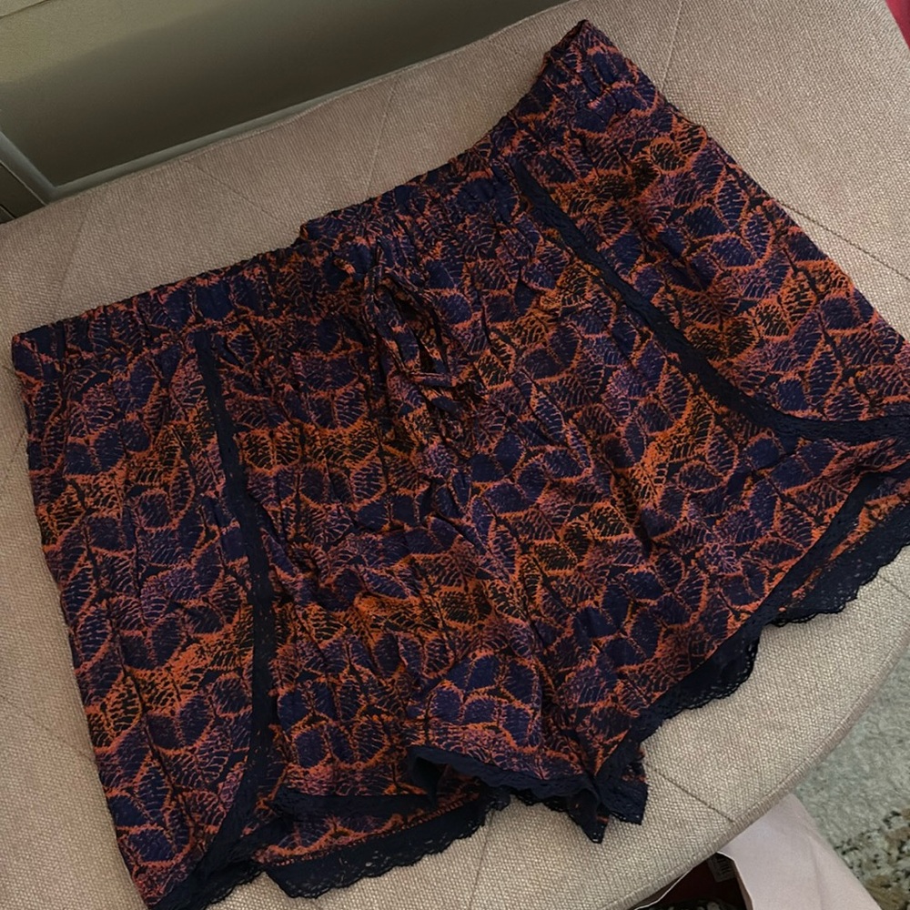 Blue flowy shorts with red-orange design. Never worn